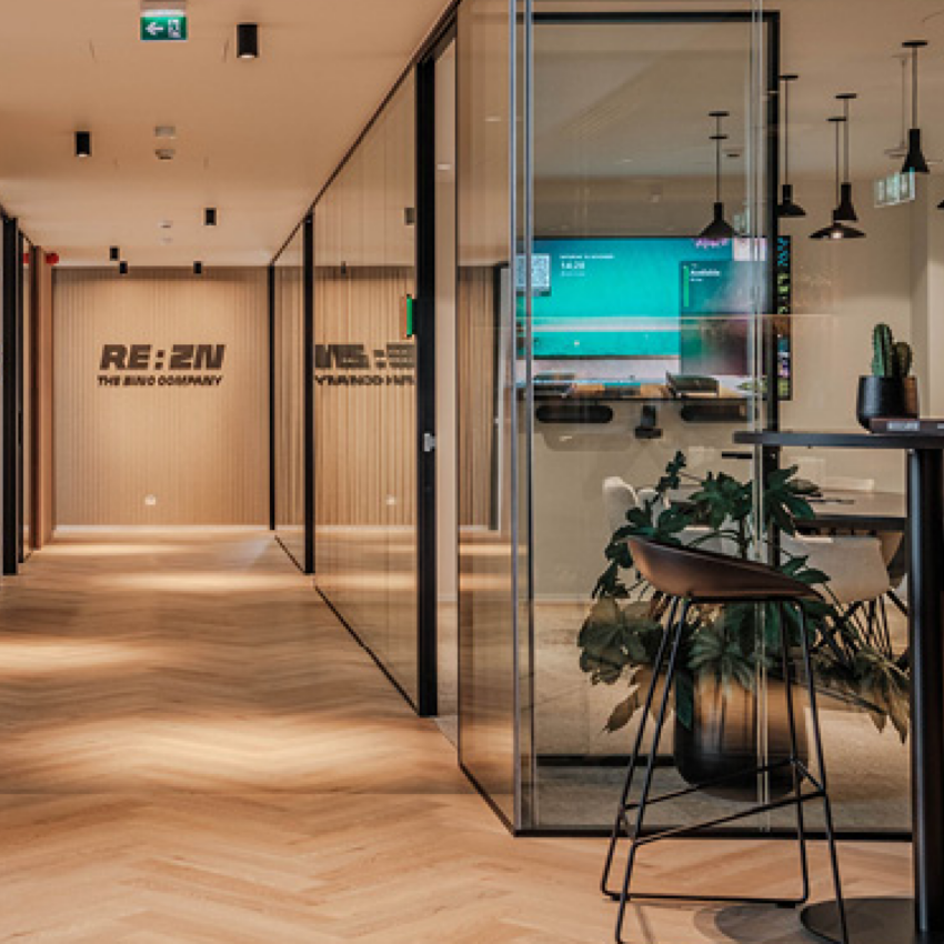 Modern office space at REAZN with REAZN signage, glass partitions, and contemporary furniture